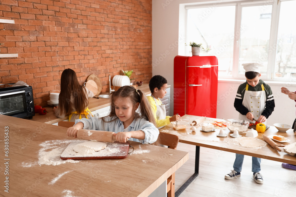 Little children during cooking class in kitchen