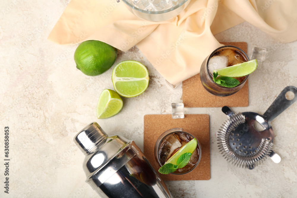 Glasses of cold Cuba Libre cocktail on light background