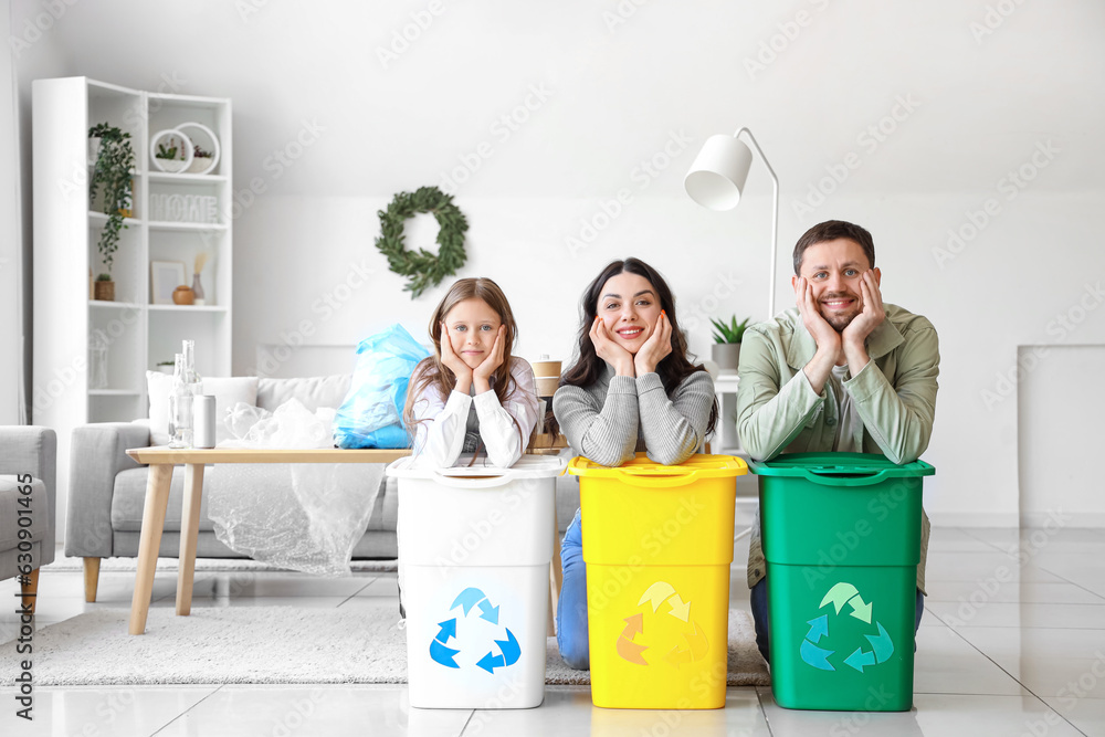 Family with recycle bins at home