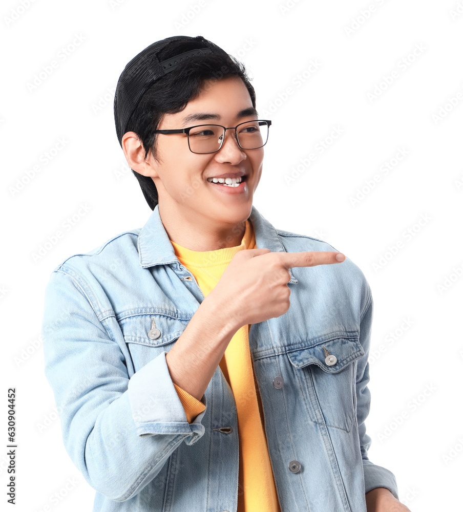 Young Asian man pointing at something on white background