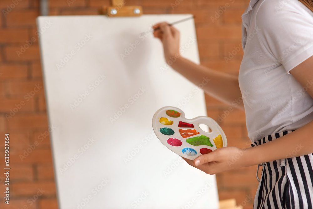 Young woman painting on her day off at home, closeup