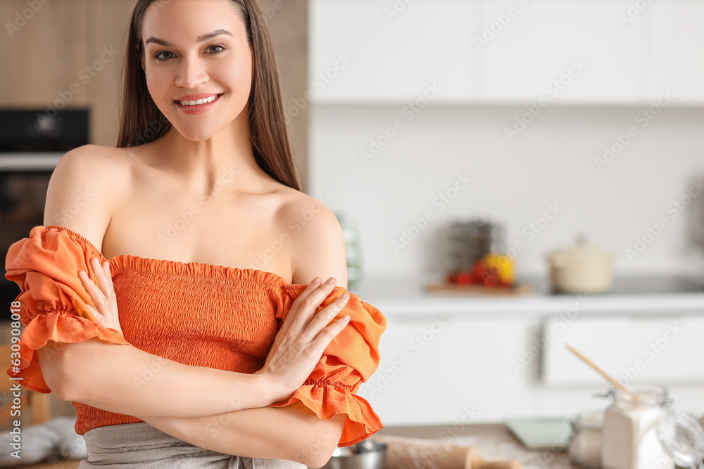 Young woman cooking in kitchen