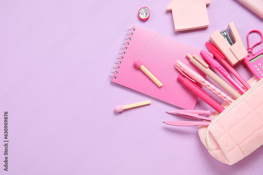 Pencil case with different school stationery on purple background