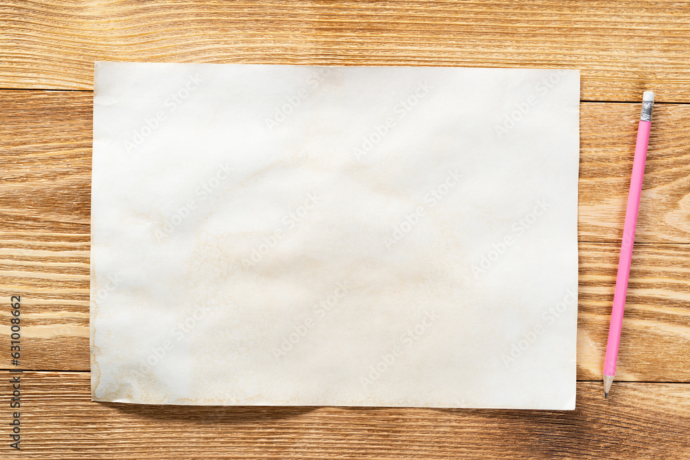 Sheet of paper lying on wooden table