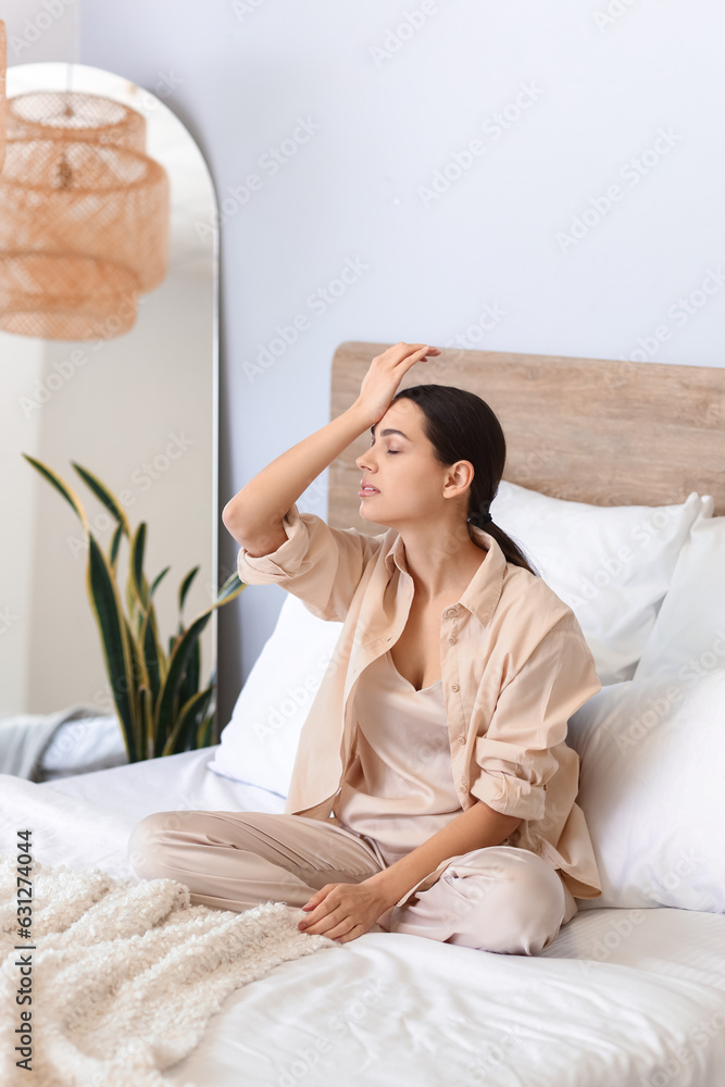 Young woman doing face building exercise in bedroom