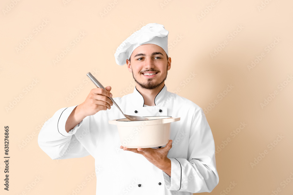 Male chef with ladle and cooking pot on beige background