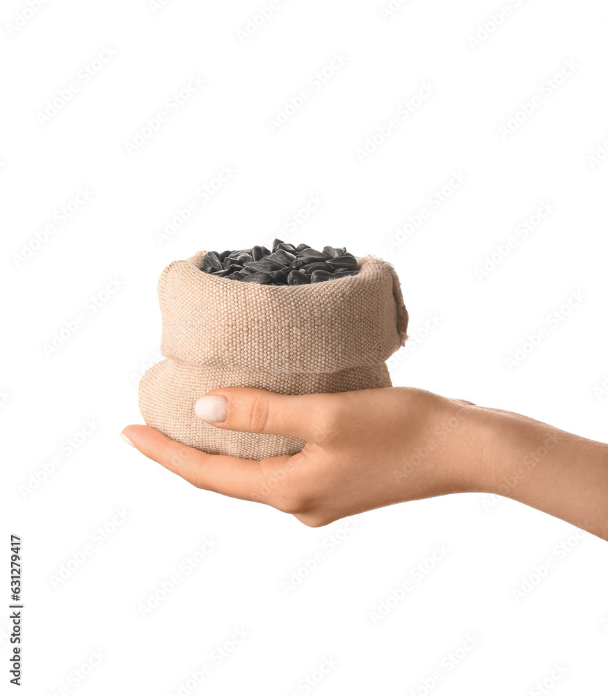 Woman holding sack with sunflower seeds on white background