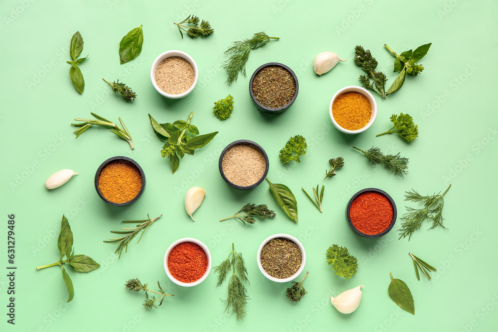 Composition with aromatic spices and fresh herbs on color background