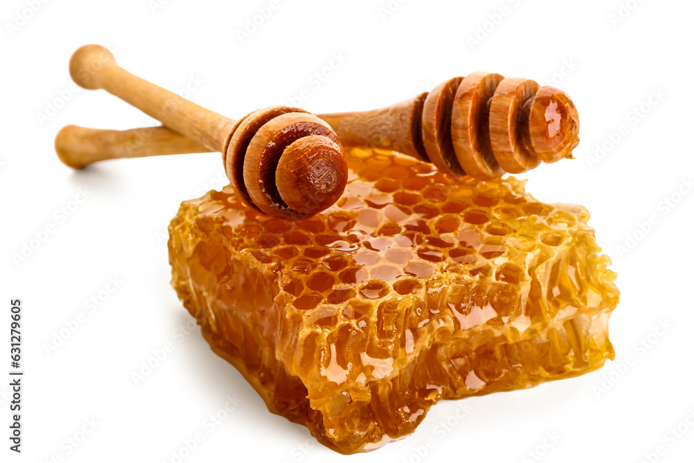 Sweet honeycomb and dippers on white background