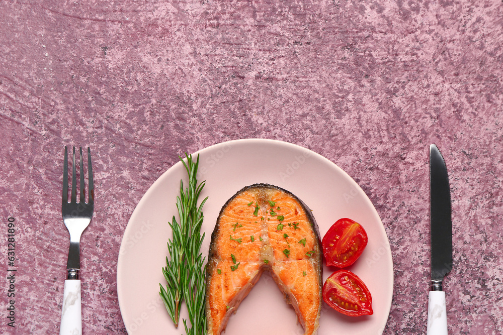 Plate of tasty salmon steak on purple background