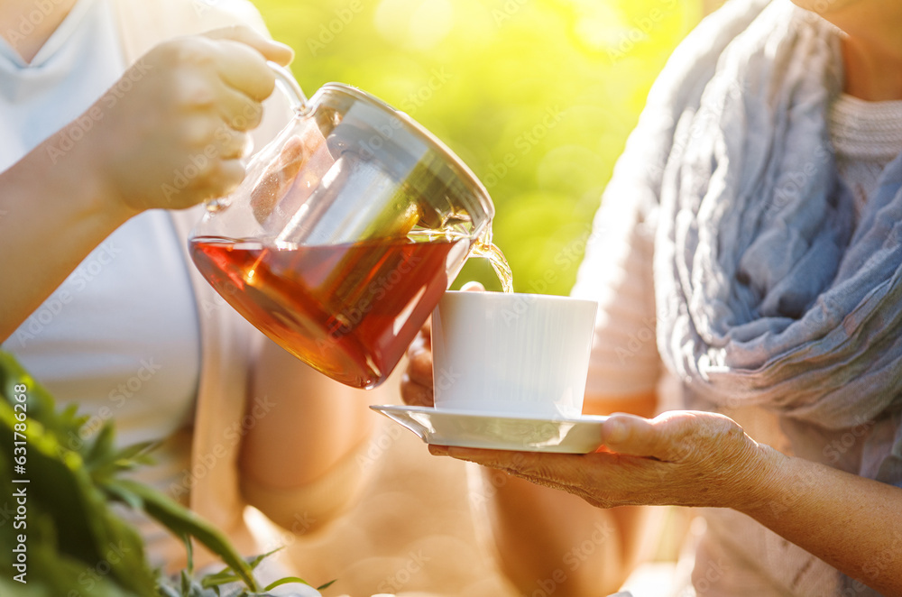 Pouring black tea into cup