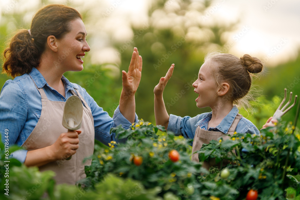 mother and daughter gardening in the backyard