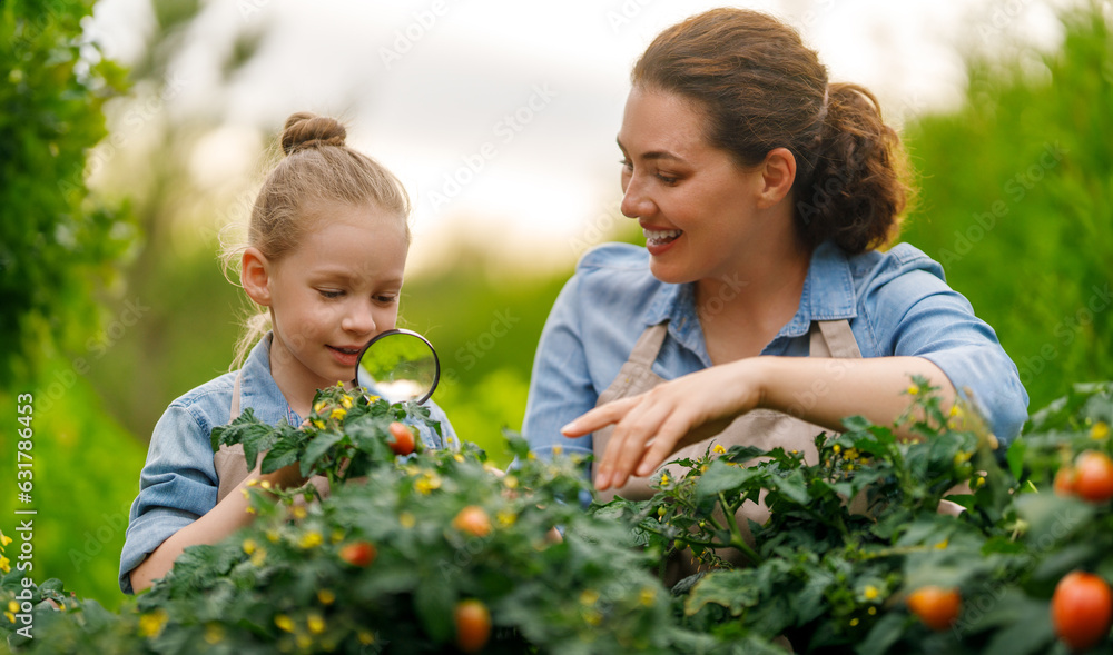 mother and daughter gardening in the backyard