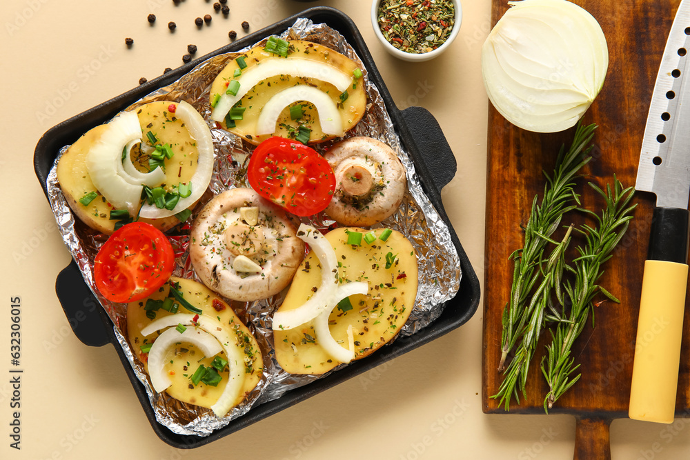 Baking dish with fresh raw vegetables, spices and rosemary on color background, closeup