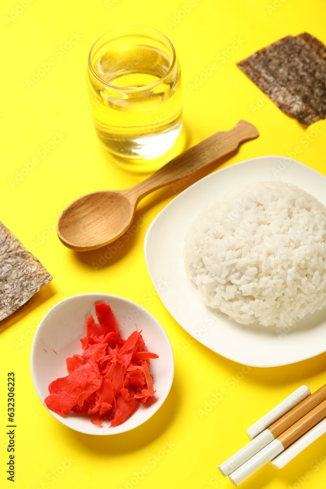 Composition with ingredients for preparing tasty sushi rolls on yellow background, closeup