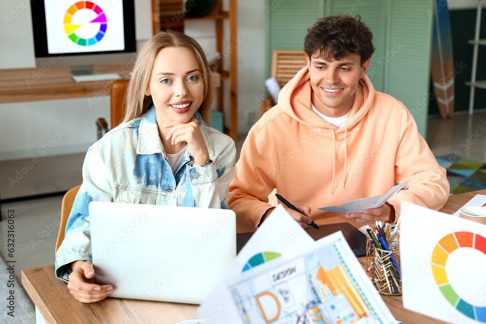 Team of graphic designers working at table in office