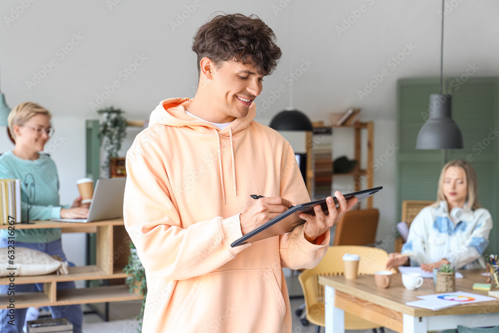 Male graphic designer working with tablet in office