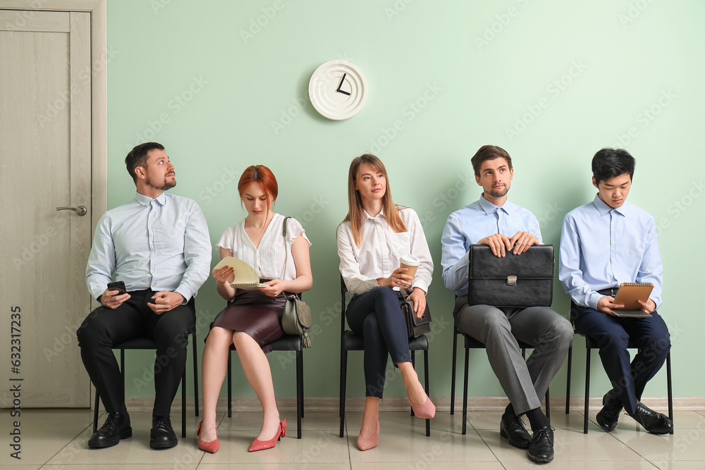 Young applicants waiting for job interview in room