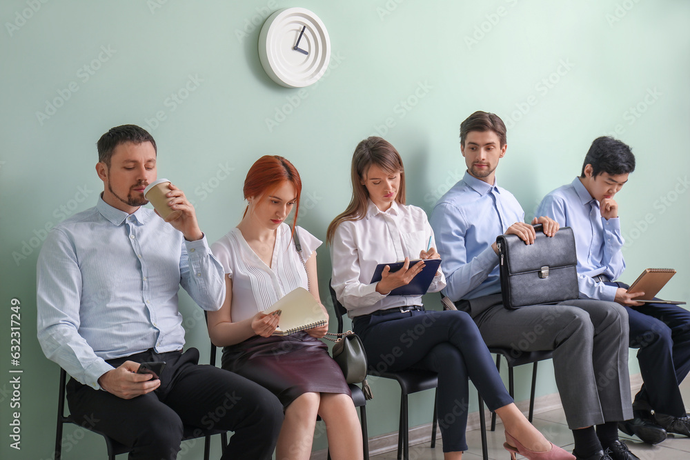 Young applicants waiting for job interview in room