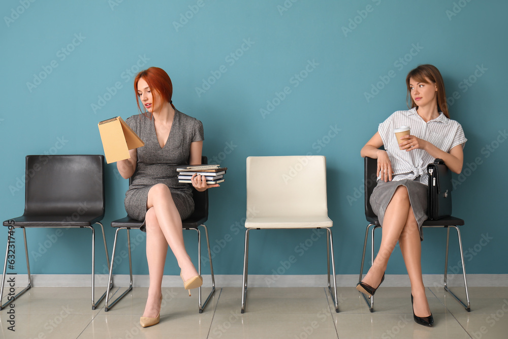 Female applicants waiting for job interview in room