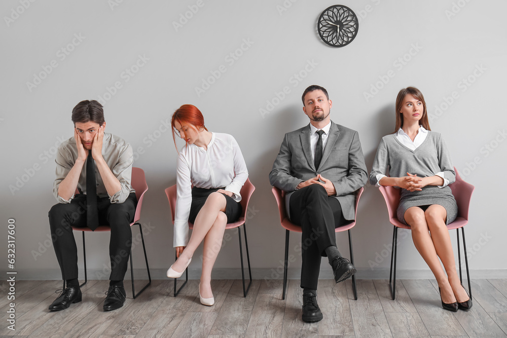 Young applicants waiting for job interview in room