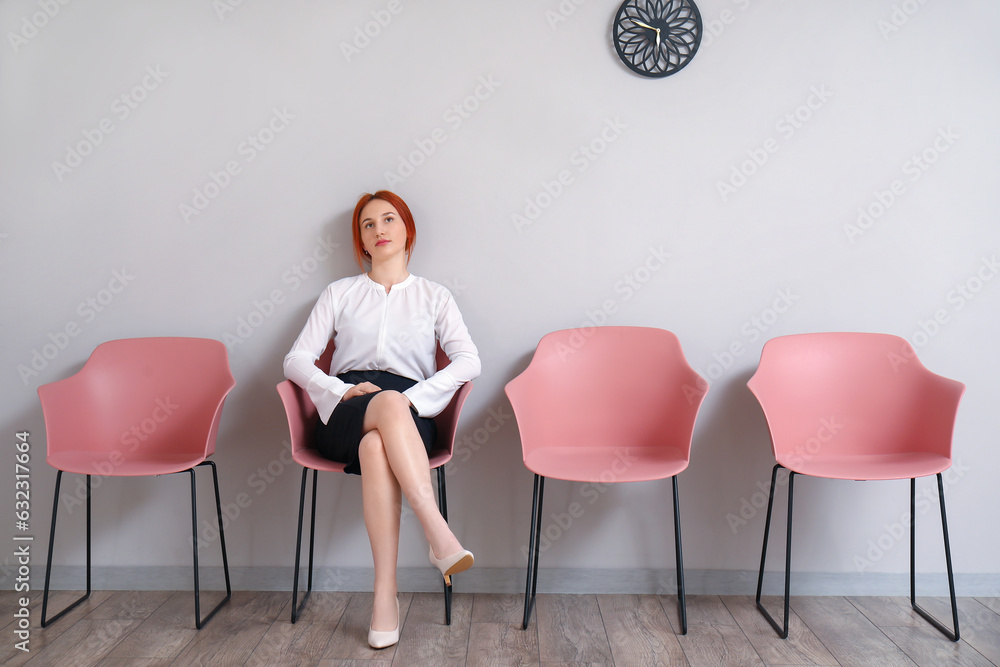 Female applicant waiting for job interview in room