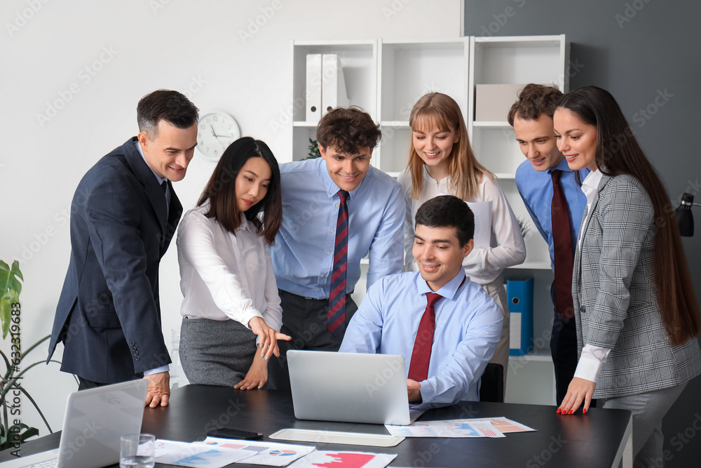 Group of business consultants working with laptop in office