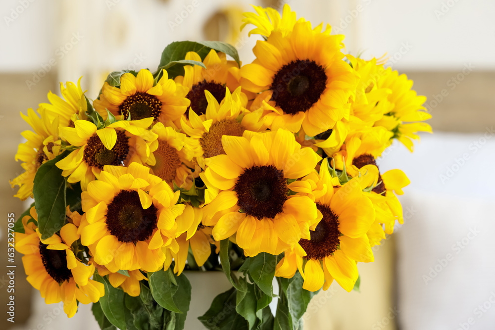 Vase with beautiful sunflowers in bedroom, closeup