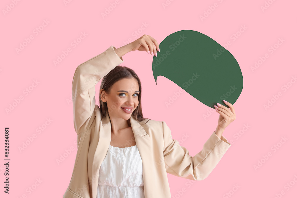 Beautiful happy young woman with speech bubble on pink background