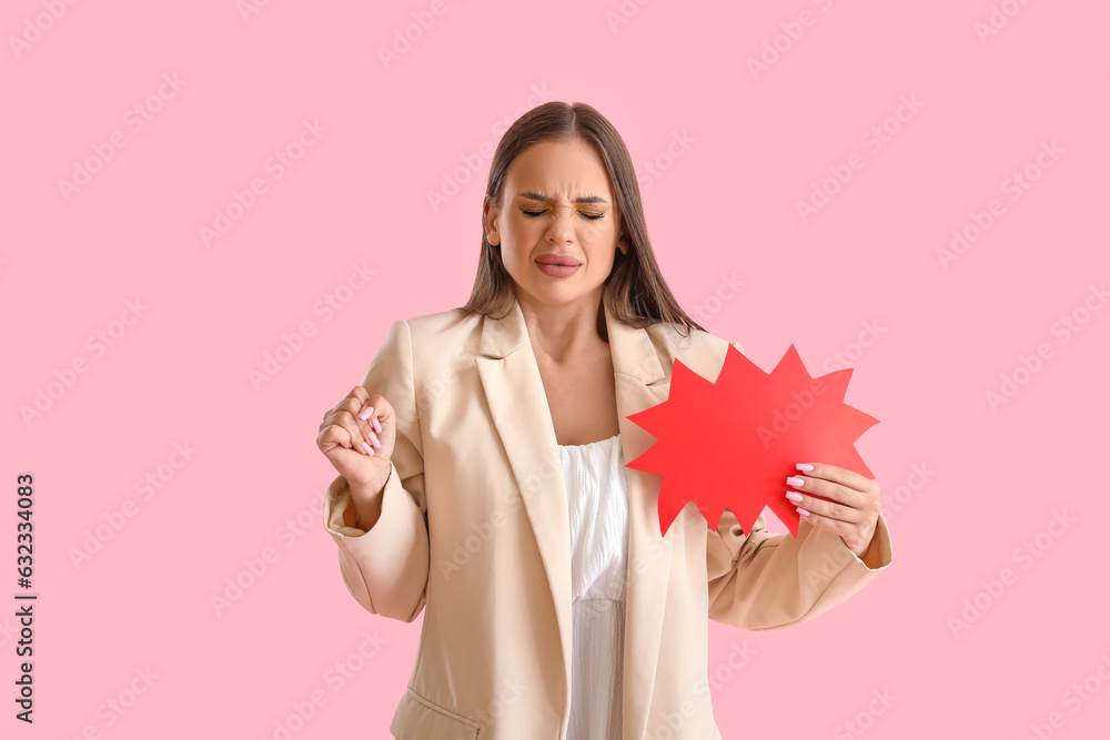 Beautiful angry young woman with speech bubble on pink background