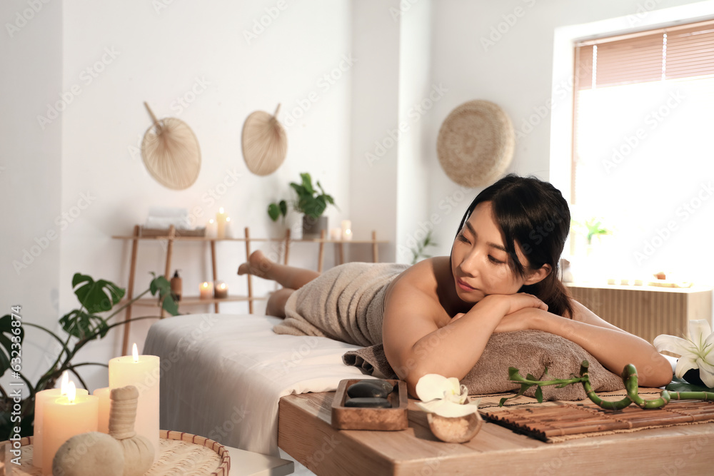 Pretty young Asian woman in spa salon