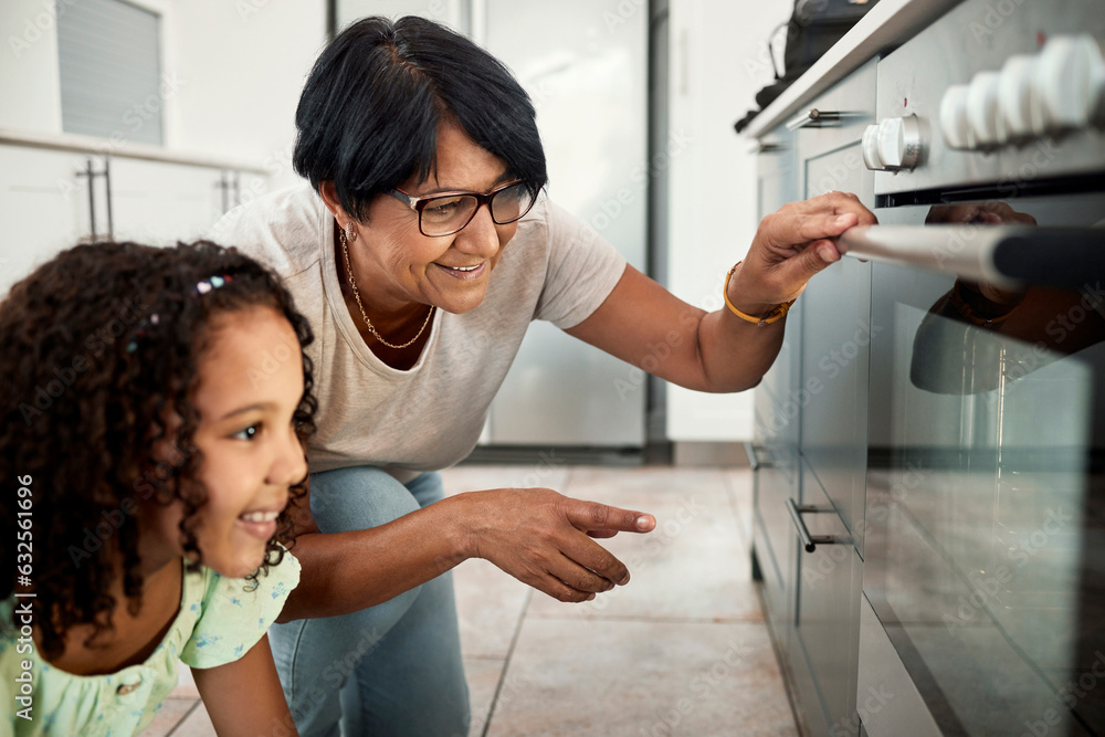 Baking, oven and a senior woman with her grandchild in the kitchen of a home together for cooking. F