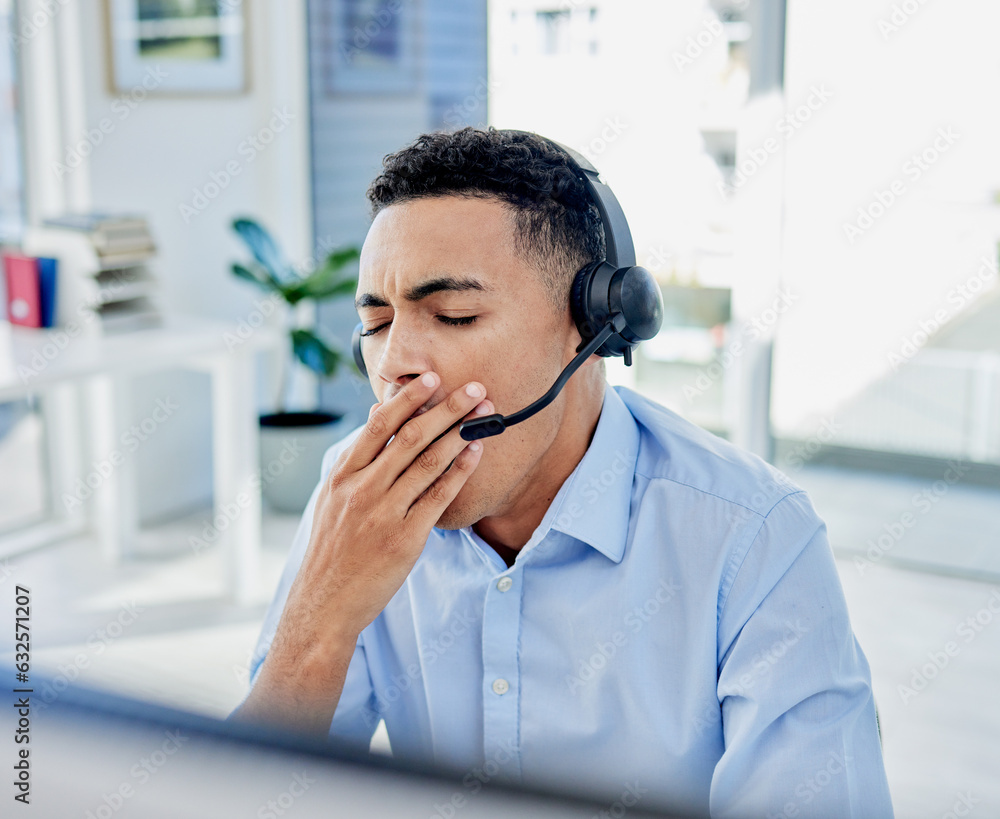 Tired, yawn and a man in a call center for customer service or support while working online at his d