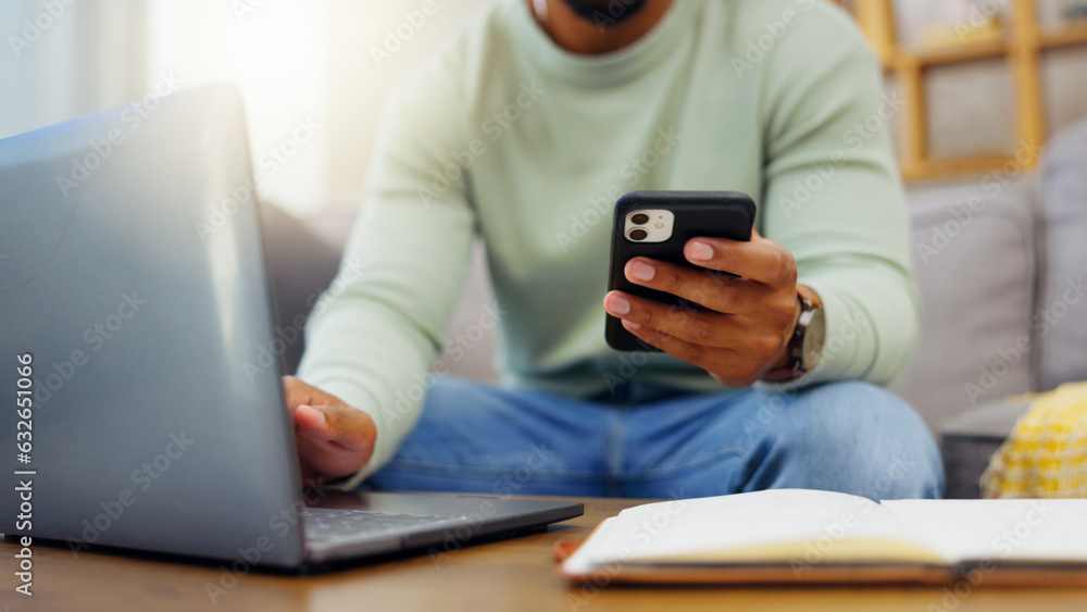 Phone, laptop and man hands typing while doing research for a freelance project in his living room. 