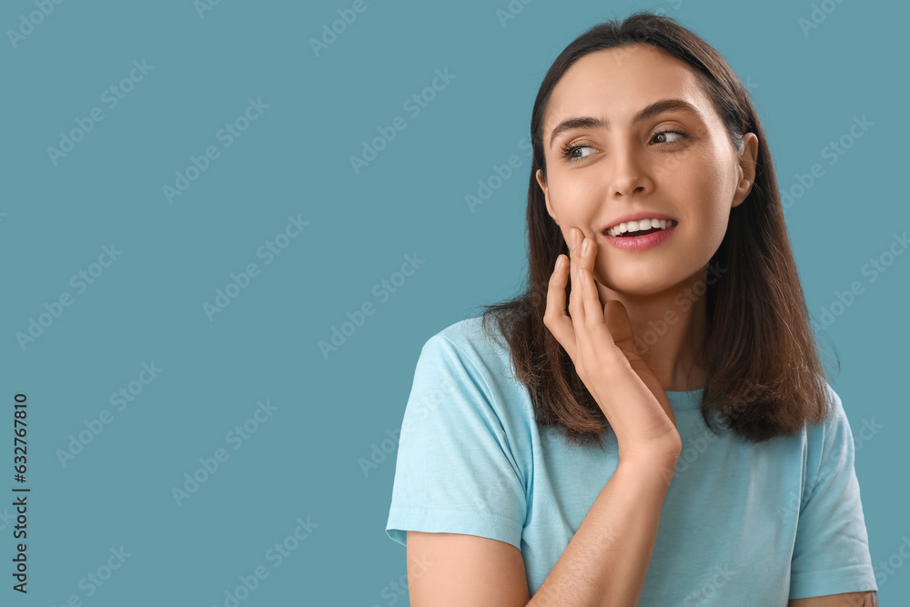 Happy young woman on blue background, closeup