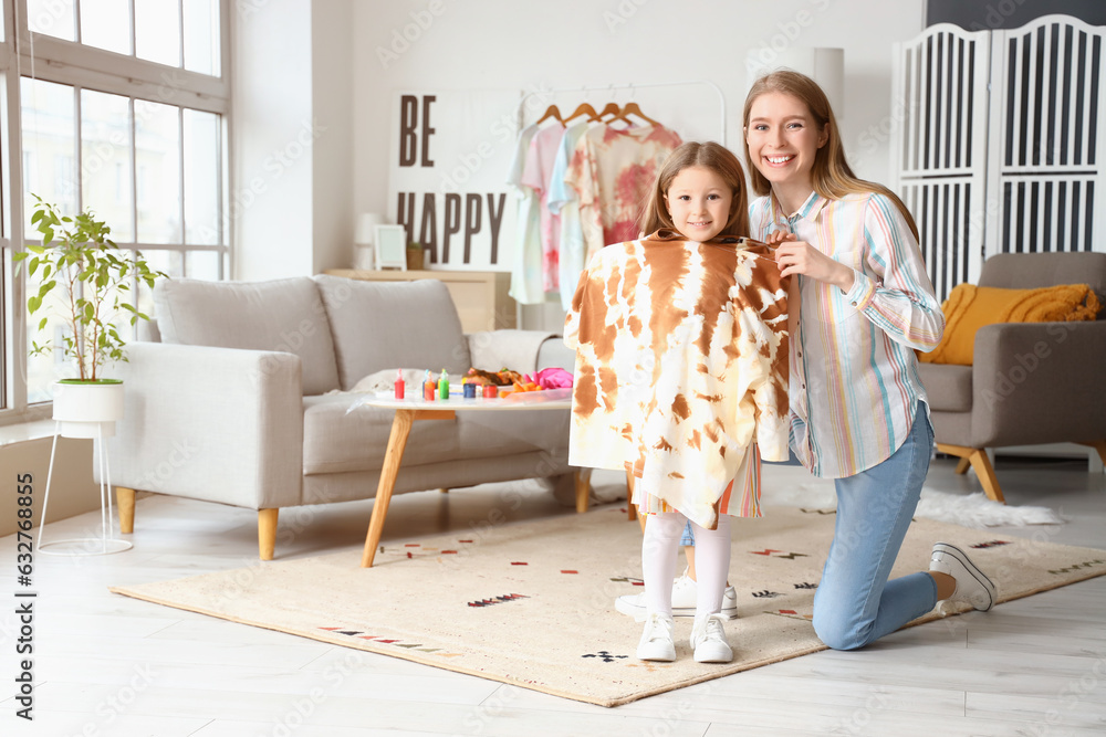 Little girl with her sister and tie-dye t-shirt at home