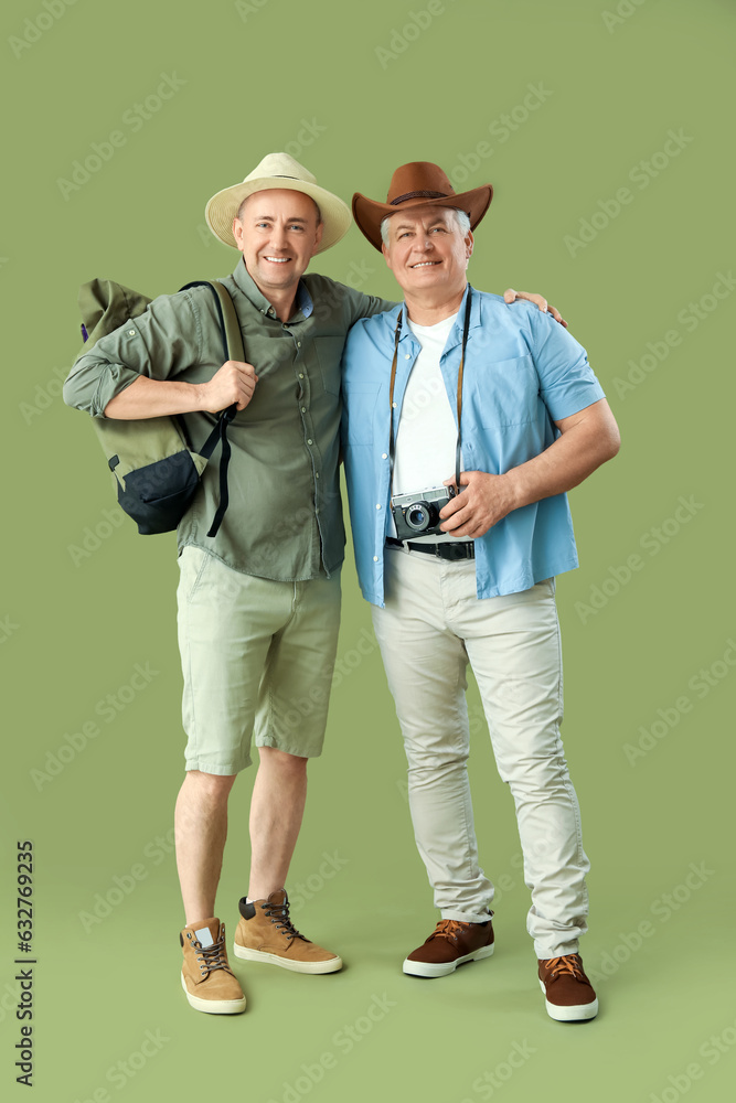 Mature tourists on green background