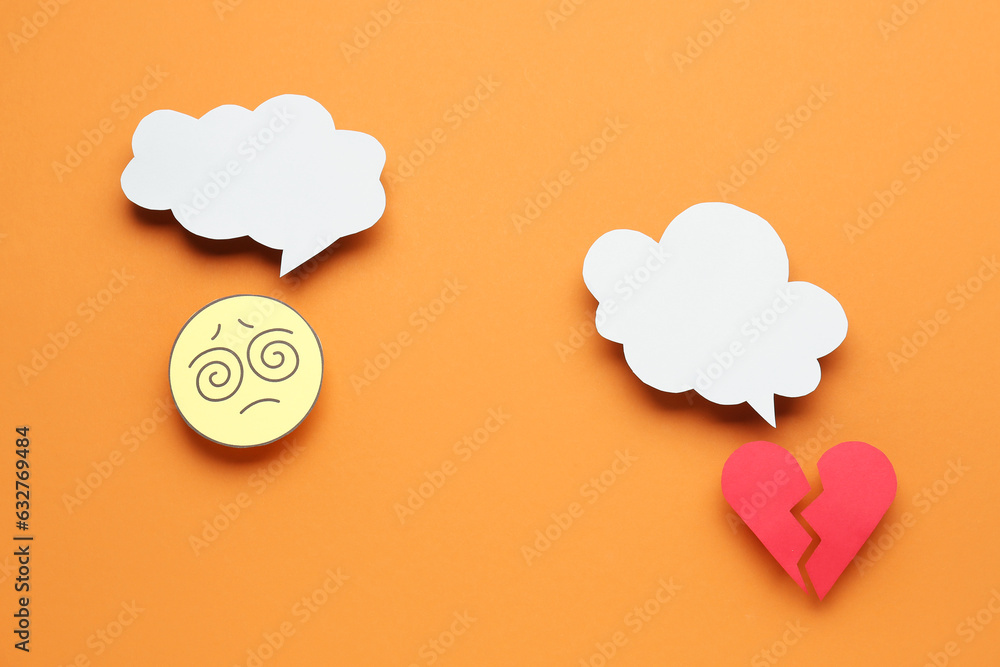 Confused paper face and broken heart with speech bubbles on orange background