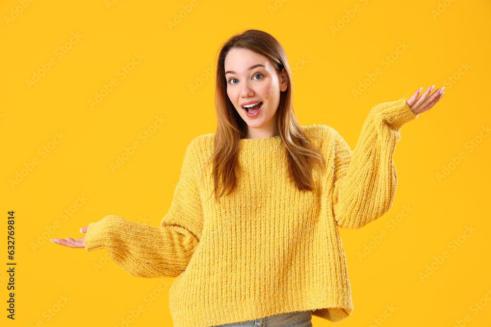 Happy young woman on yellow background