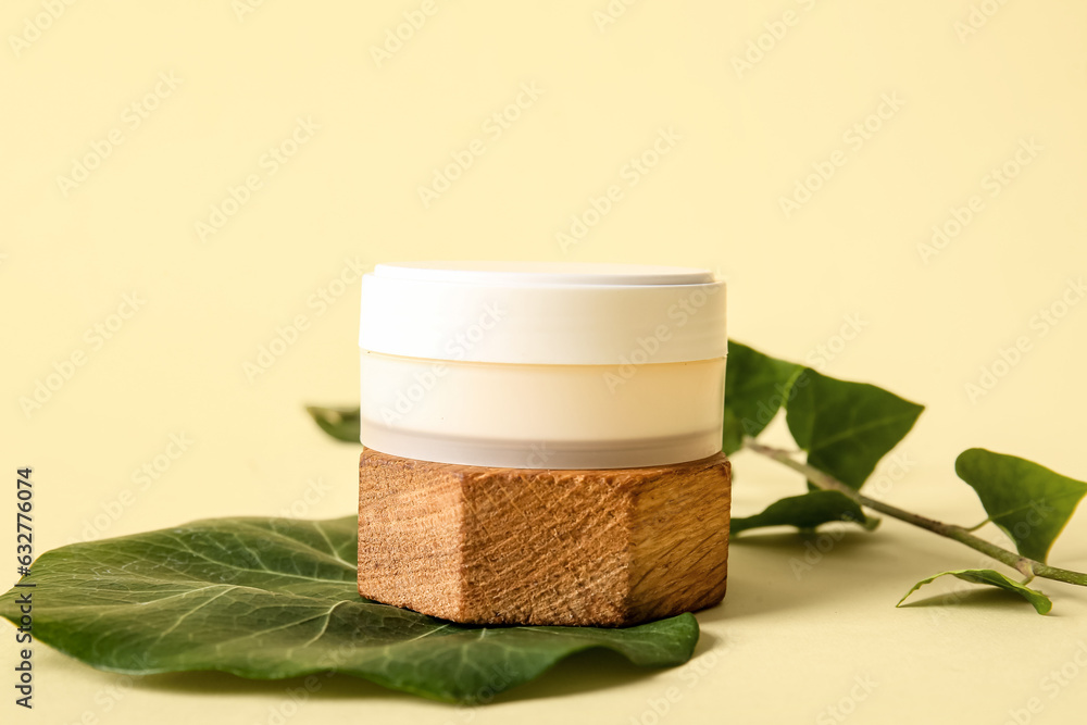 Composition with jar of cosmetic product and ivy branch on color background