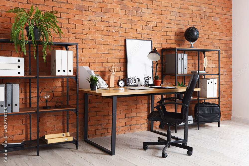 Interior of office with workplace and shelving units