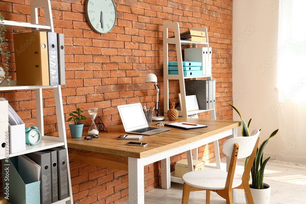 Interior of office with workplace and shelving units