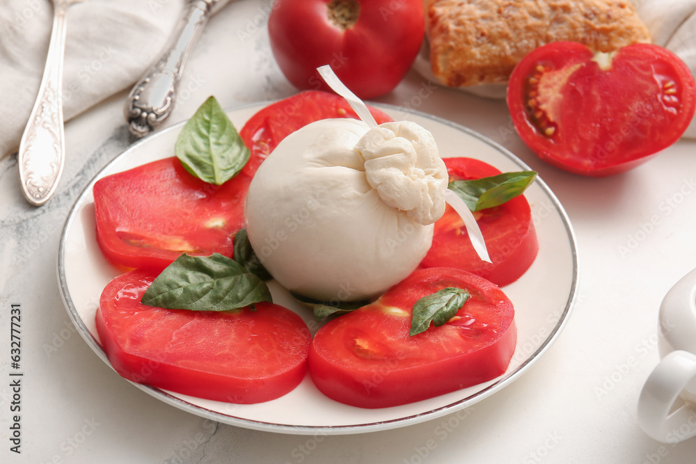 Plate with tasty Burrata cheese on white marble background