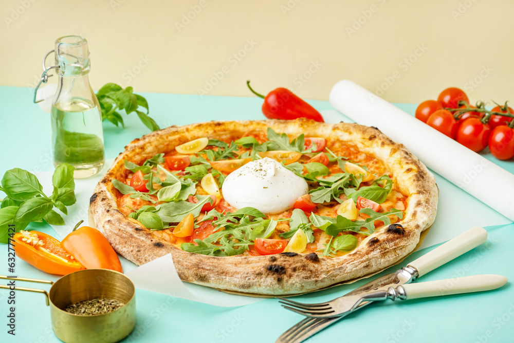 Tasty pizza with Burrata cheese on green background