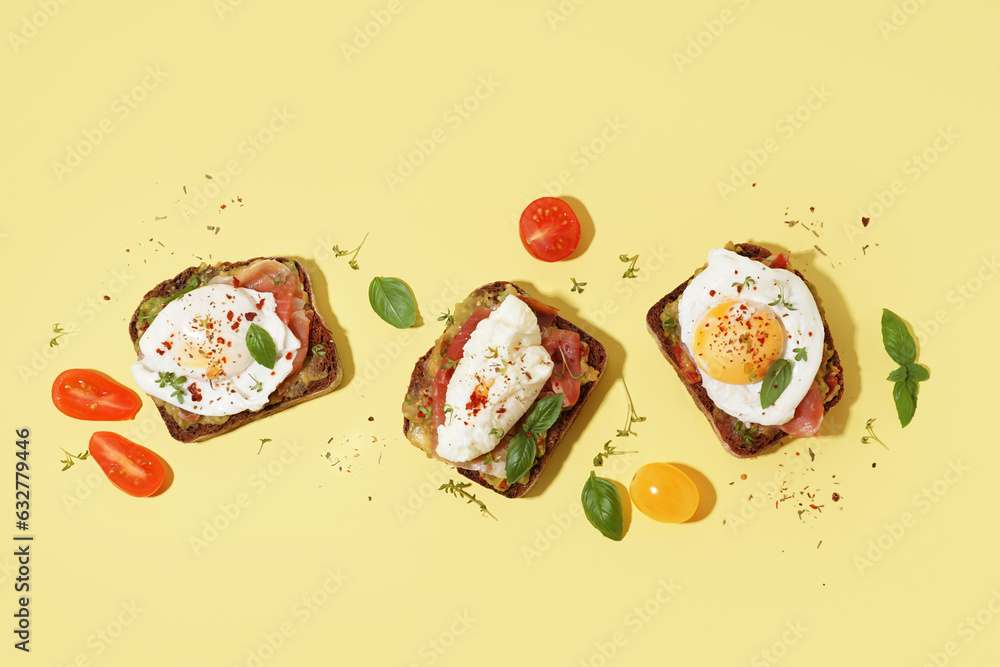 Tasty sandwiches with egg on yellow background