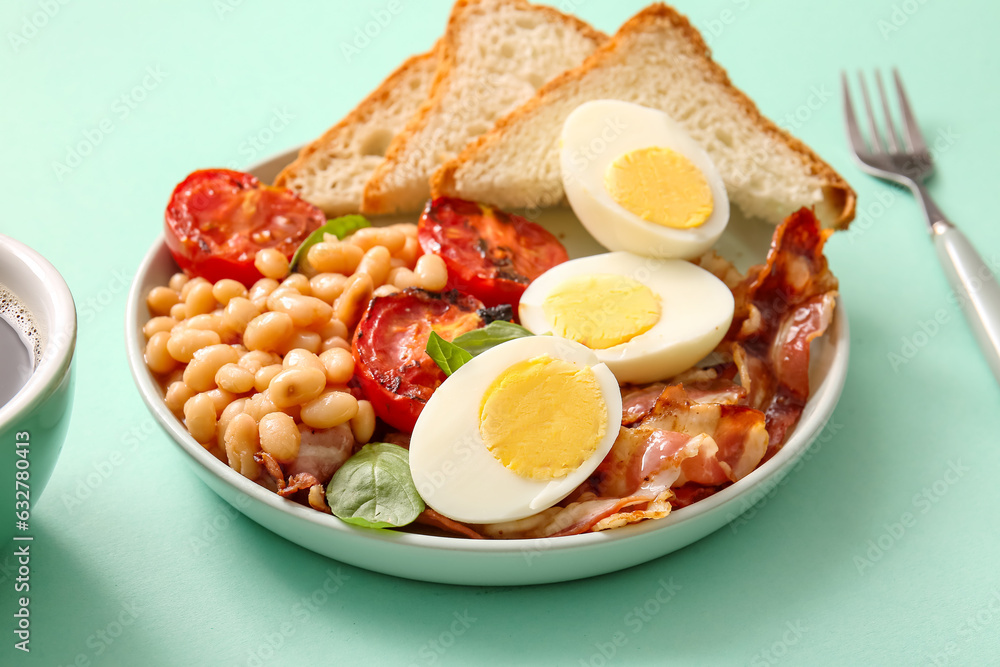 Plate of tasty English breakfast with boiled eggs on turquoise background