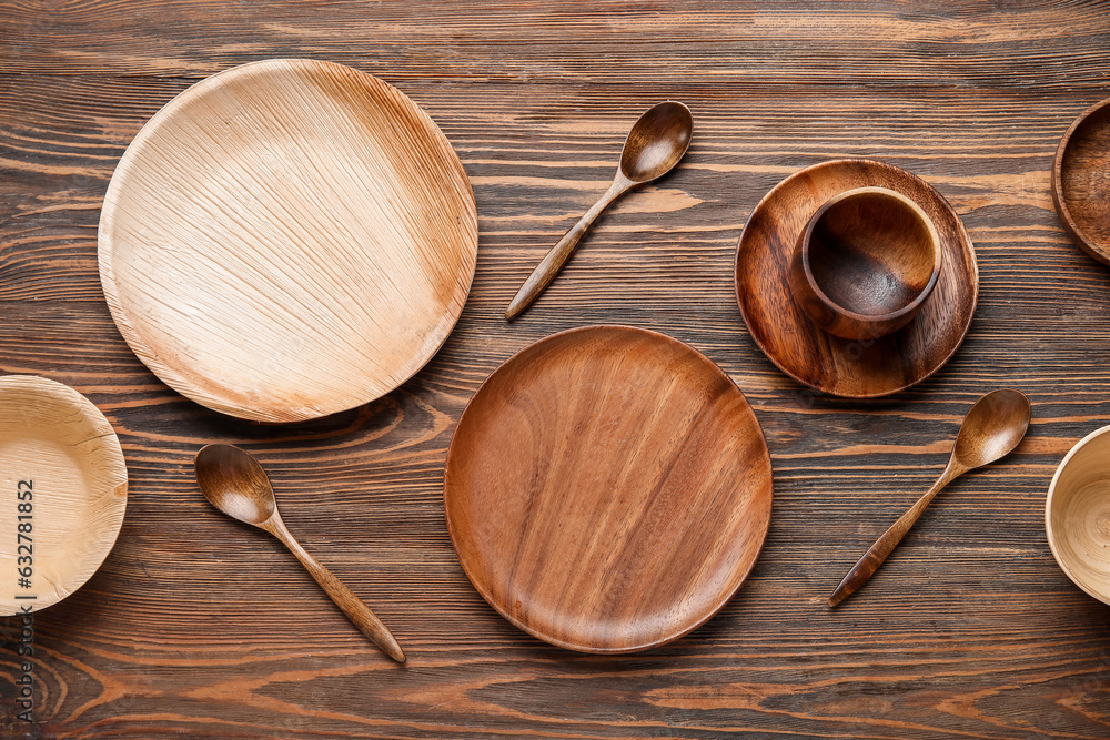 Different tableware on wooden background