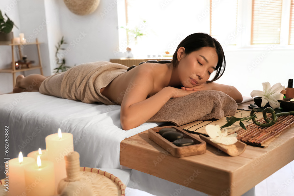 Pretty young Asian woman in spa salon