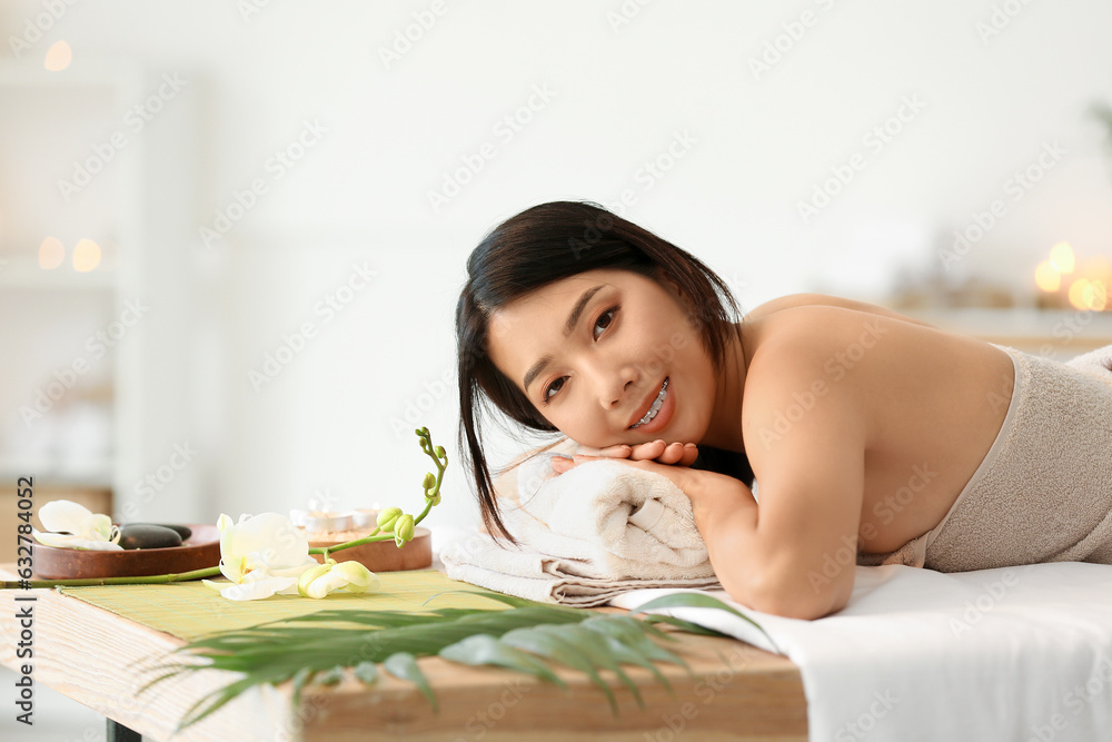 Pretty young Asian woman in spa salon