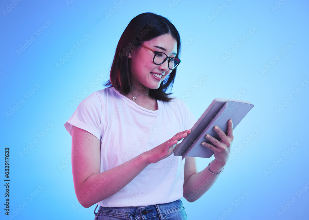 Young woman, student and tablet for online education, e learning and study on blue, studio backgroun